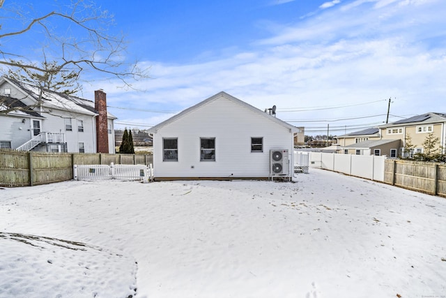 view of snow covered rear of property