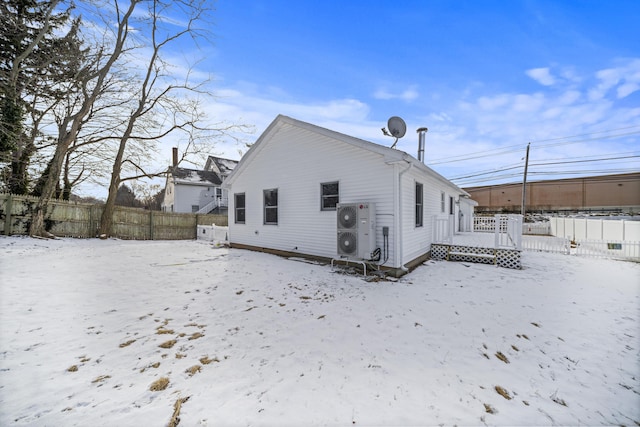 view of snow covered rear of property