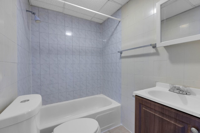 full bathroom featuring toilet, tile walls, shower / tub combination, vanity, and tile patterned flooring