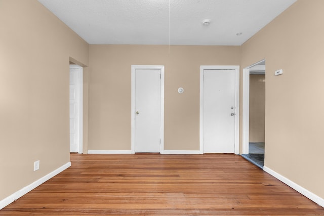 empty room featuring light hardwood / wood-style floors and a textured ceiling