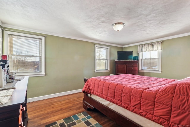 bedroom with ornamental molding, dark hardwood / wood-style floors, and a textured ceiling