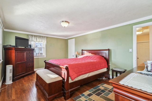 bedroom with ornamental molding and dark hardwood / wood-style flooring