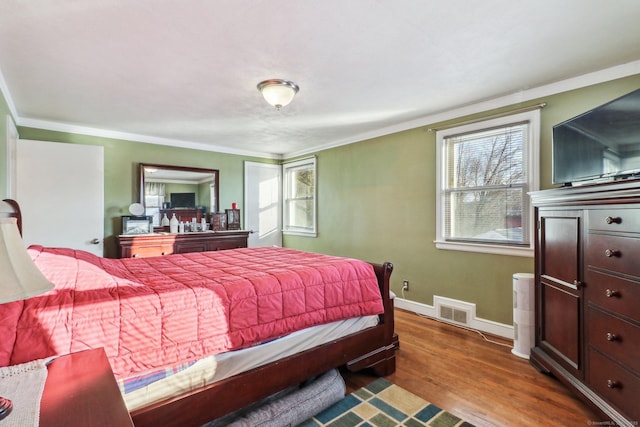 bedroom with crown molding and wood-type flooring