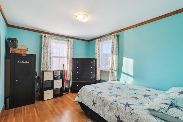 bedroom featuring wood-type flooring and ornamental molding