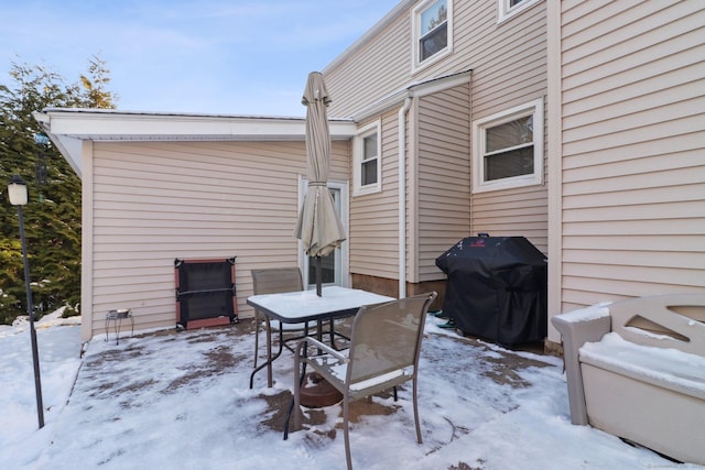 snow covered patio with grilling area