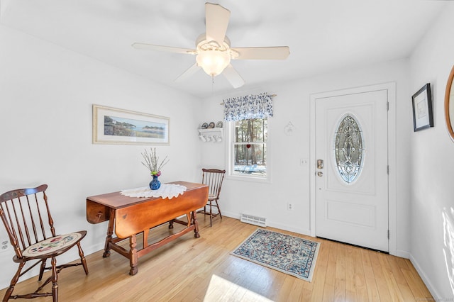 foyer entrance featuring ceiling fan and light wood-type flooring