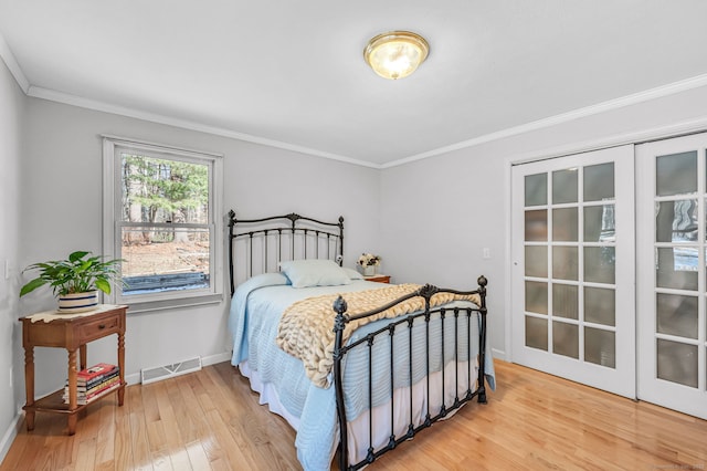 bedroom featuring crown molding and hardwood / wood-style flooring