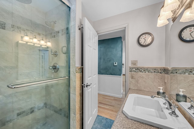 bathroom featuring hardwood / wood-style flooring, sink, and walk in shower