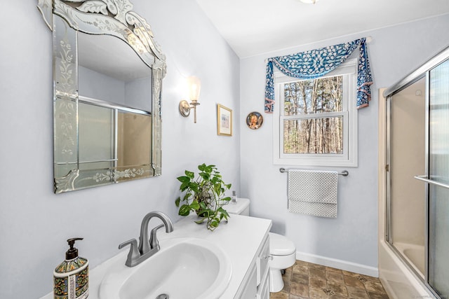 full bathroom with shower / bath combination with glass door, vanity, and toilet