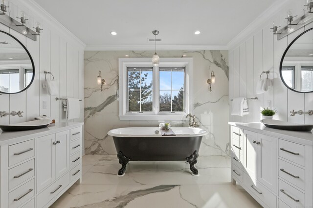 bathroom featuring ornamental molding, vanity, and a washtub