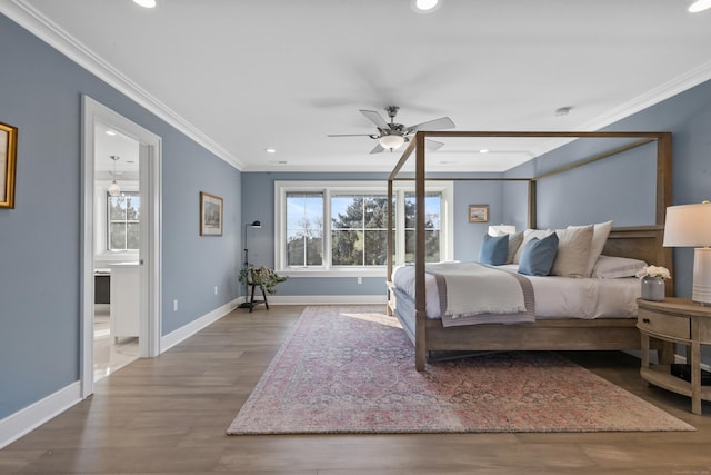 bedroom featuring hardwood / wood-style flooring, crown molding, and ensuite bathroom