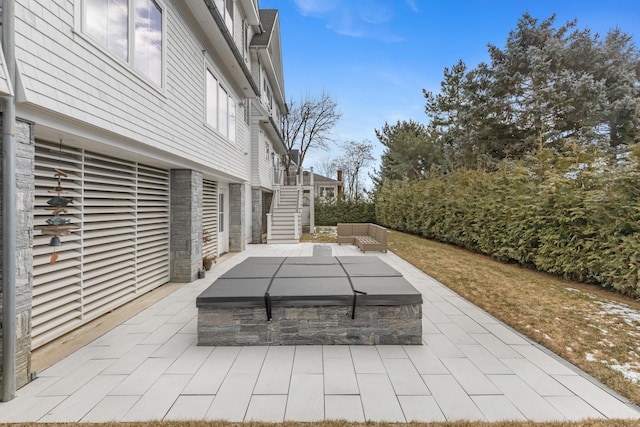 view of patio / terrace featuring a covered hot tub