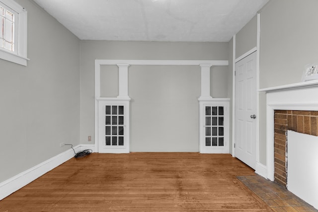 unfurnished living room featuring a brick fireplace