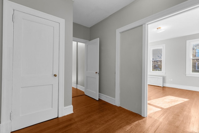 hall featuring hardwood / wood-style floors and radiator heating unit