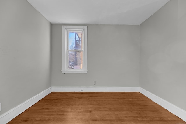 empty room with hardwood / wood-style floors