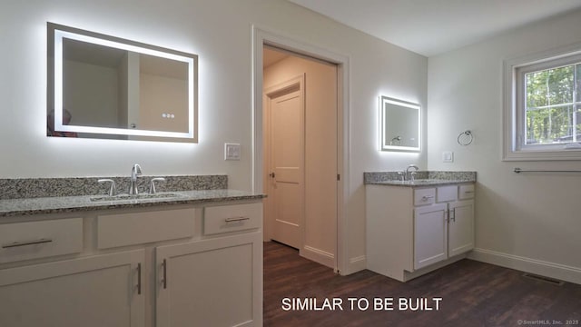 bathroom with hardwood / wood-style flooring and vanity