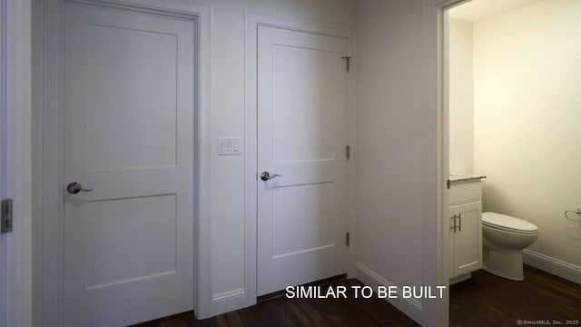 bathroom featuring vanity, hardwood / wood-style floors, and toilet