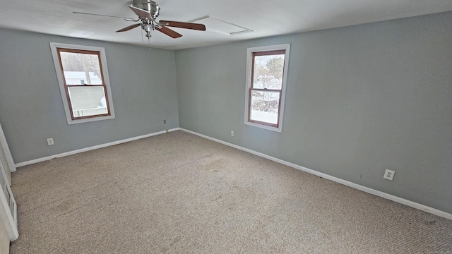 carpeted spare room with ceiling fan