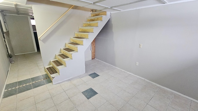 basement featuring light tile patterned floors