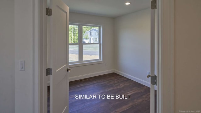 spare room with dark hardwood / wood-style floors