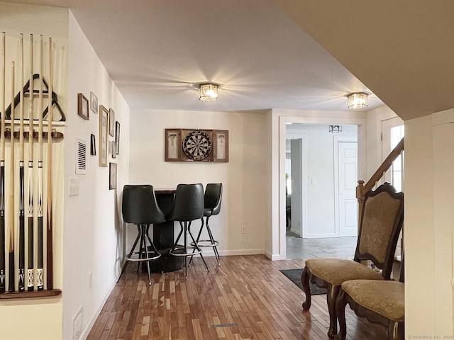 bar with hardwood / wood-style flooring