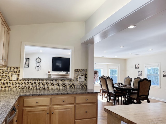 kitchen with tasteful backsplash, light brown cabinetry, and light hardwood / wood-style flooring