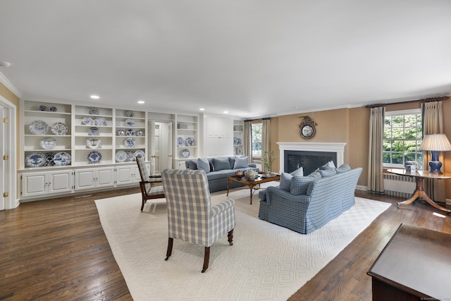 living room with wood-type flooring, radiator, and built in features