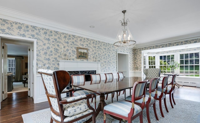 dining space featuring crown molding, dark hardwood / wood-style flooring, and an inviting chandelier