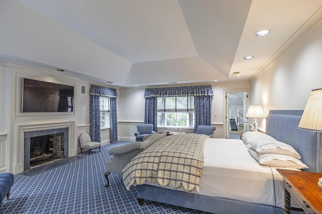 bedroom with crown molding and a tray ceiling