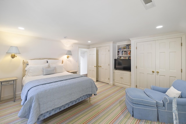 bedroom featuring crown molding and light colored carpet