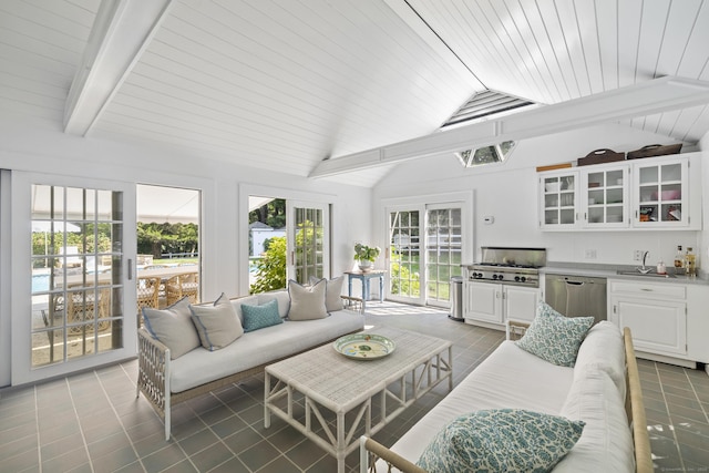 sunroom / solarium with vaulted ceiling with beams, wooden ceiling, and sink