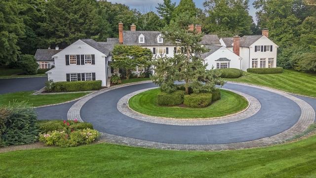 view of home's community featuring a lawn