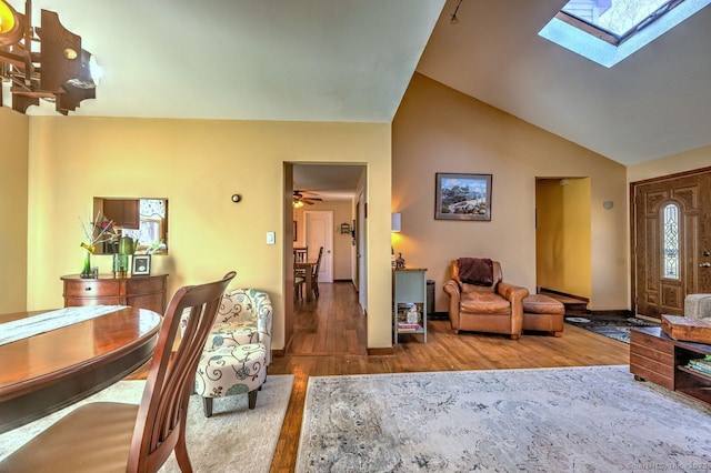 living room with lofted ceiling with skylight and hardwood / wood-style floors