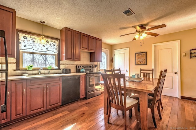 kitchen with black dishwasher, sink, dark hardwood / wood-style flooring, hanging light fixtures, and electric range