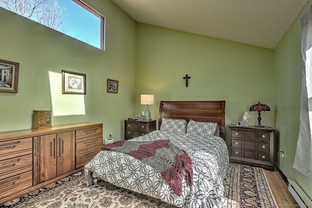 bedroom with a baseboard radiator, high vaulted ceiling, and light hardwood / wood-style floors