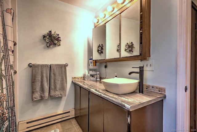 bathroom with a baseboard radiator, vanity, and tile patterned flooring