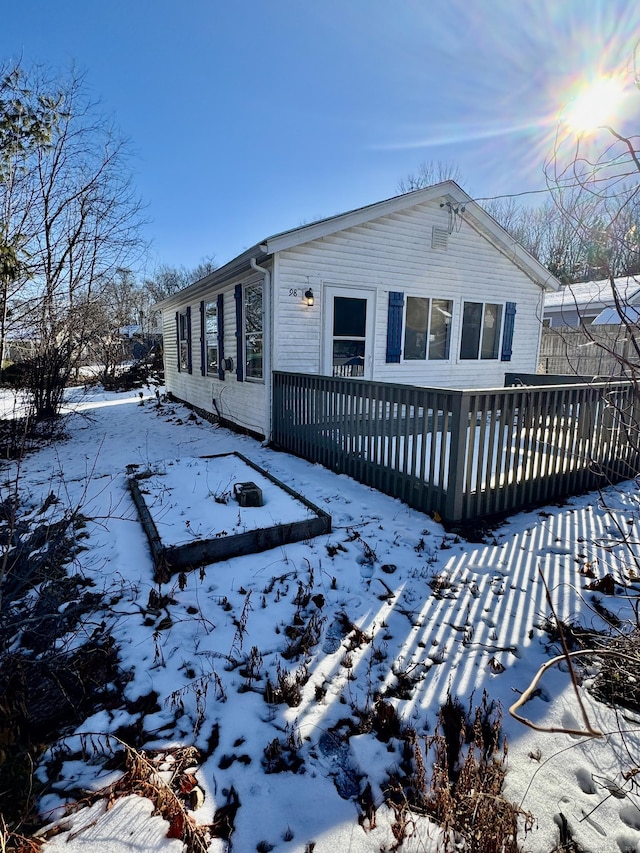 snow covered property featuring a wooden deck