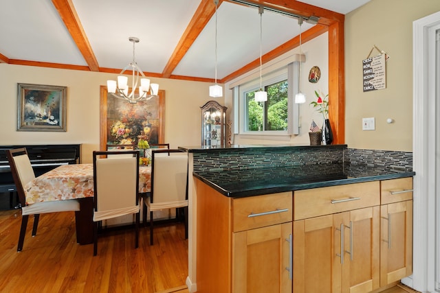 kitchen featuring light brown cabinetry, decorative light fixtures, tasteful backsplash, wood-type flooring, and beam ceiling