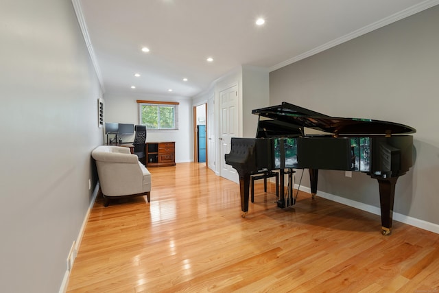 living area with ornamental molding and light wood-type flooring