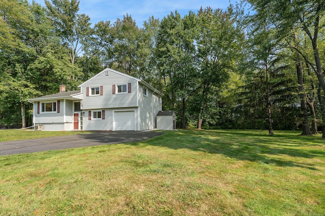 view of front of home with a garage and a front lawn