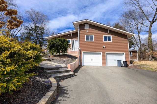 view of home's exterior featuring driveway and a garage