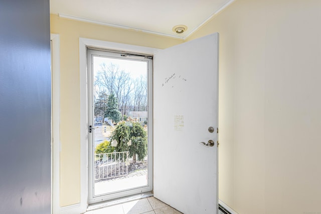 entryway with light tile patterned floors and ornamental molding