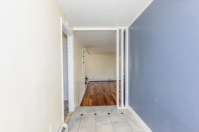 hall featuring tile patterned flooring, a baseboard heating unit, and baseboards