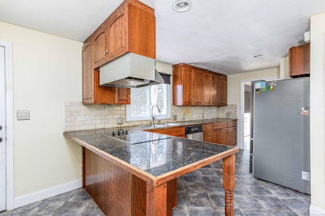 kitchen featuring brown cabinets, custom range hood, a sink, stainless steel appliances, and tile counters