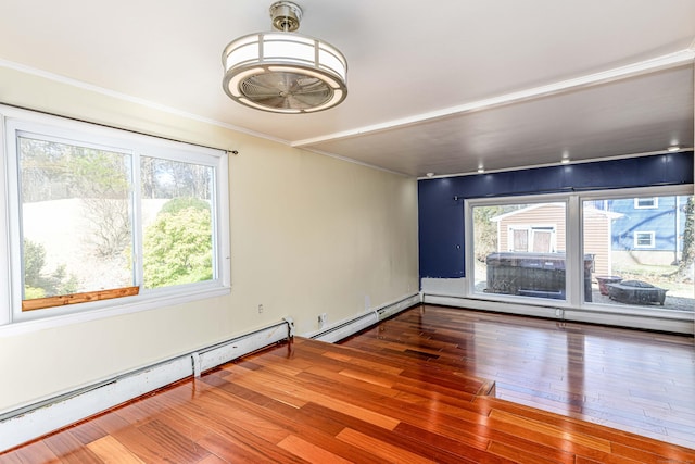 unfurnished room featuring hardwood / wood-style floors and crown molding