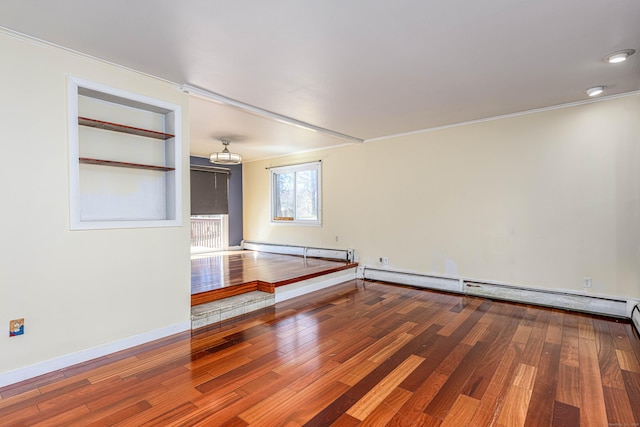 unfurnished room with ornamental molding, wood-type flooring, and a baseboard radiator