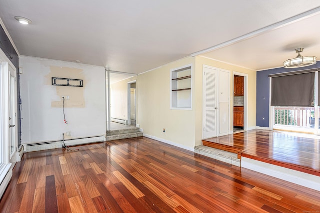 unfurnished room with wood finished floors, baseboards, baseboard heating, and a baseboard radiator