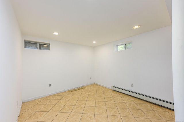 basement with a baseboard heating unit and recessed lighting