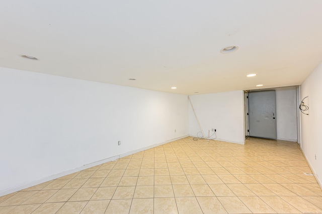 spare room featuring recessed lighting and baseboards