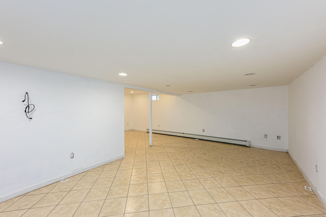 finished basement featuring recessed lighting, baseboards, baseboard heating, and light tile patterned flooring